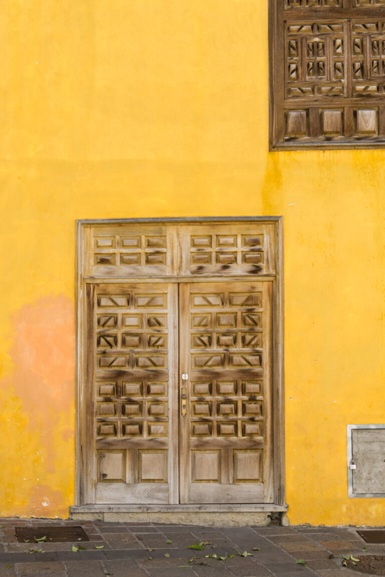 La Gomera senfgelbe Wand mit schweren Holztüren und Fensterläden geschnitzt